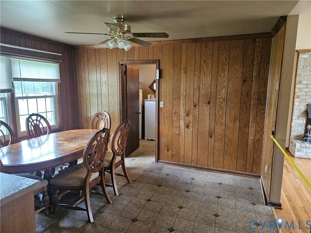 13336 Ladysmith Road Ruther Glen, VA 22580 - Photo 17 of 27 Dining area featuring wooden walls, tile patterned