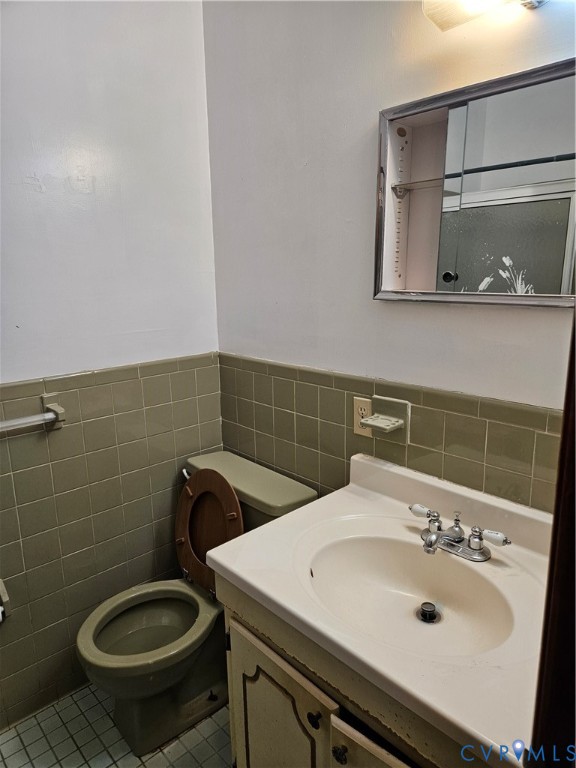 13336 Ladysmith Road Ruther Glen, VA 22580 - Photo 19 of 27 Bathroom with tile walls, vanity, tile patterned f