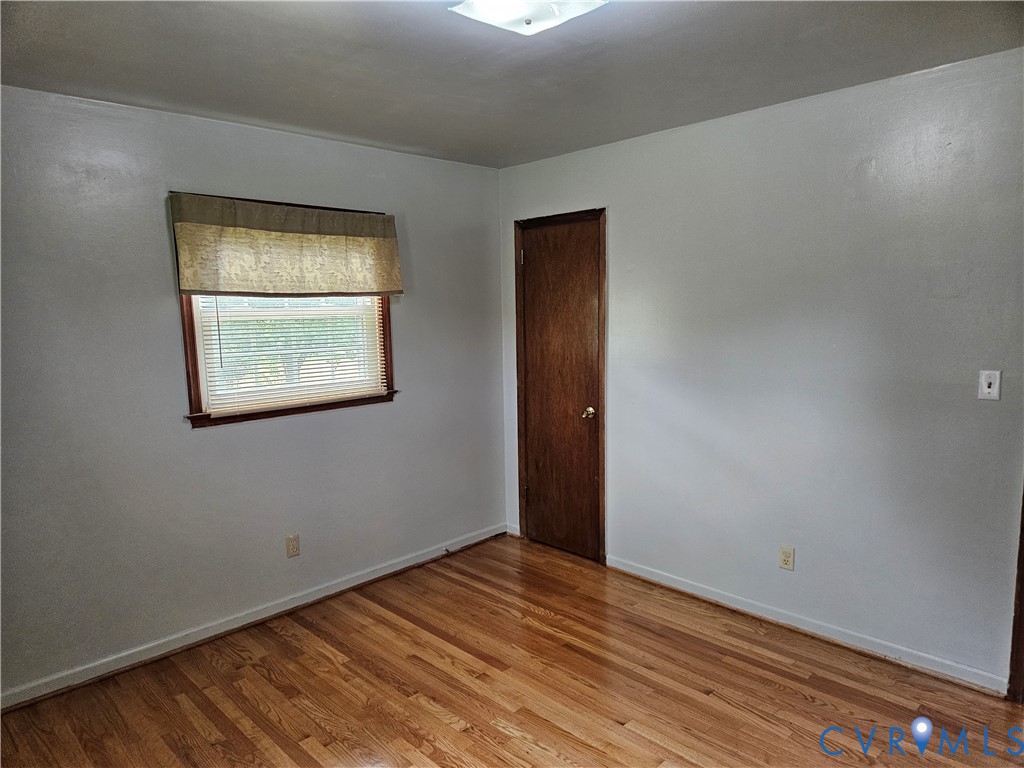 13336 Ladysmith Road Ruther Glen, VA 22580 - Photo 23 of 27 Spare room featuring wood finished floors and base