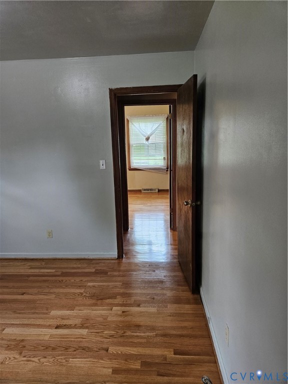 13336 Ladysmith Road Ruther Glen, VA 22580 - Photo 24 of 27 Corridor featuring wood finished floors and basebo