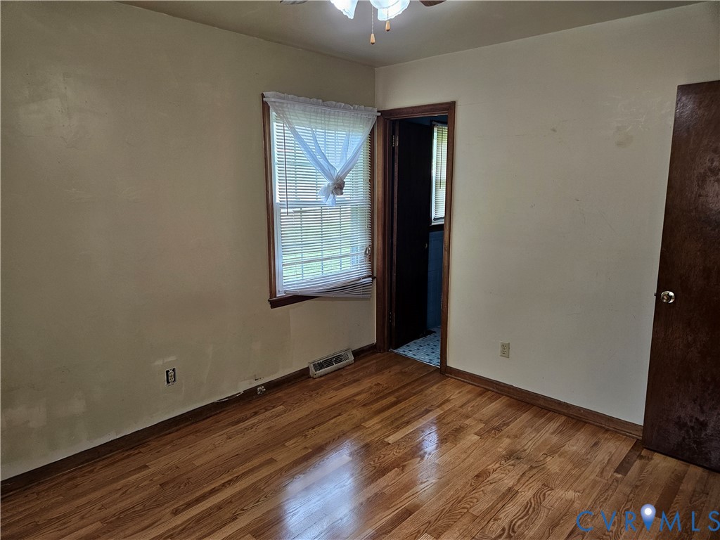 13336 Ladysmith Road Ruther Glen, VA 22580 - Photo 26 of 27 Unfurnished room with wood finished floors and a c