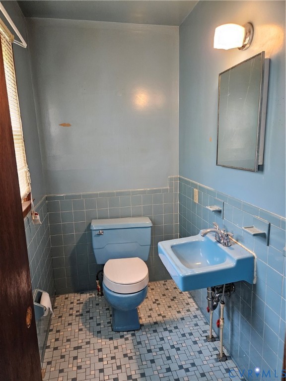 13336 Ladysmith Road Ruther Glen, VA 22580 - Photo 27 of 27 Bathroom featuring tile walls, wainscoting, and ti