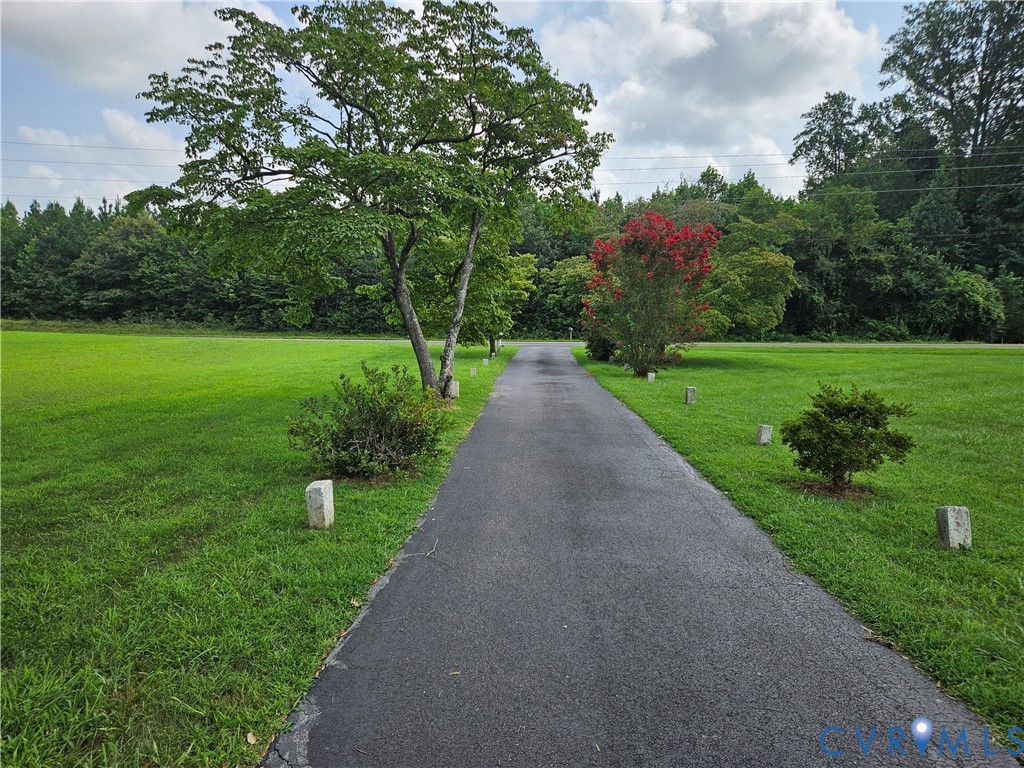View of property's community featuring a yard