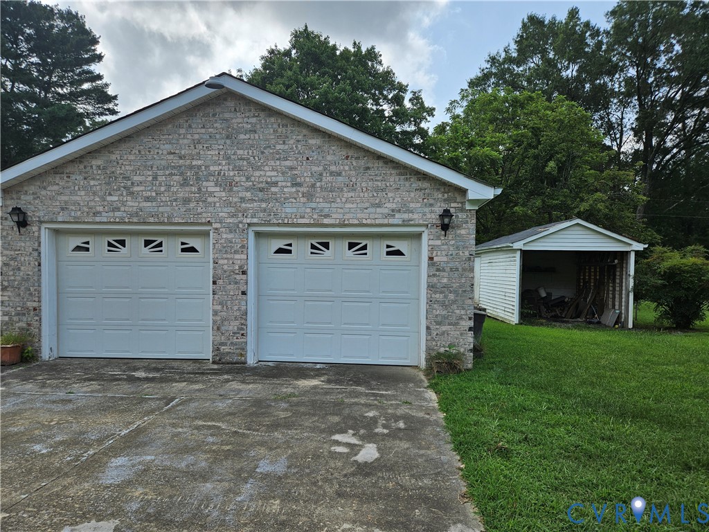Garage featuring driveway