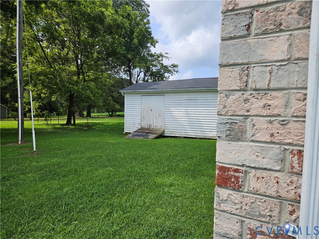 13336 Ladysmith Road Ruther Glen, VA 22580 - Photo 8 of 27 View of grassy yard featuring a storage shed
