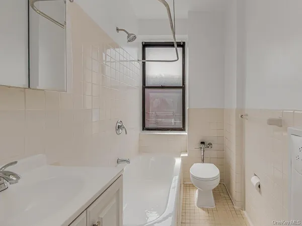 a bathroom with a toilet a sink and bathtub