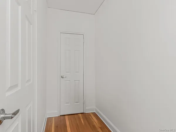 a view of walk in closet with wooden floor