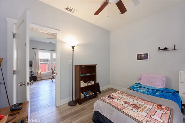 a bedroom with a bed and a tv on table