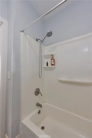 a bathroom with a tub and a shower