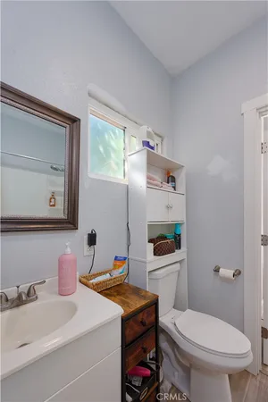 a bathroom with a sink a toilet and mirror