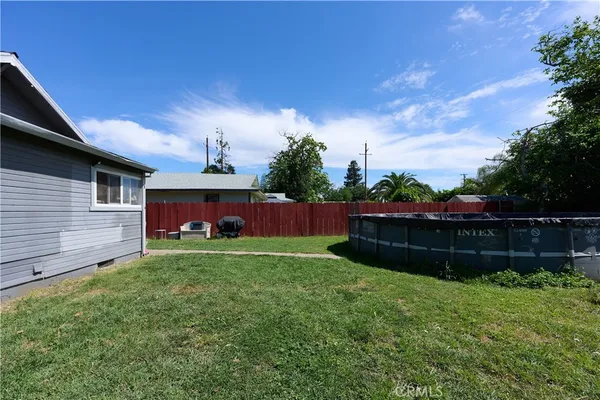 a view of house with backyard