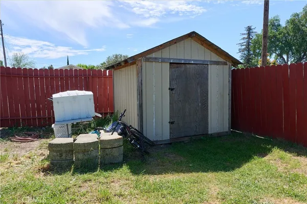 a backyard of a house with chairs and a yard