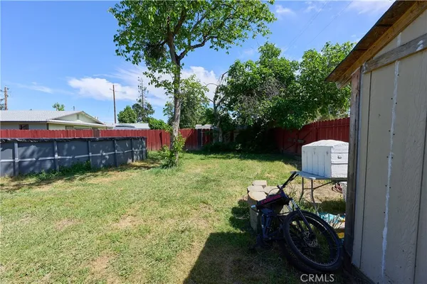 a backyard of a house with yard and outdoor seating