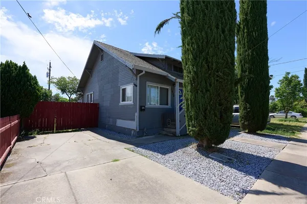 a view of backyard of house with green space