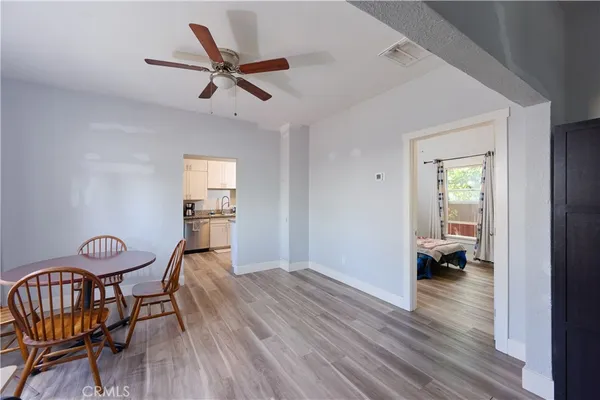 a view of a livingroom with furniture wooden floor a ceiling fan and a window