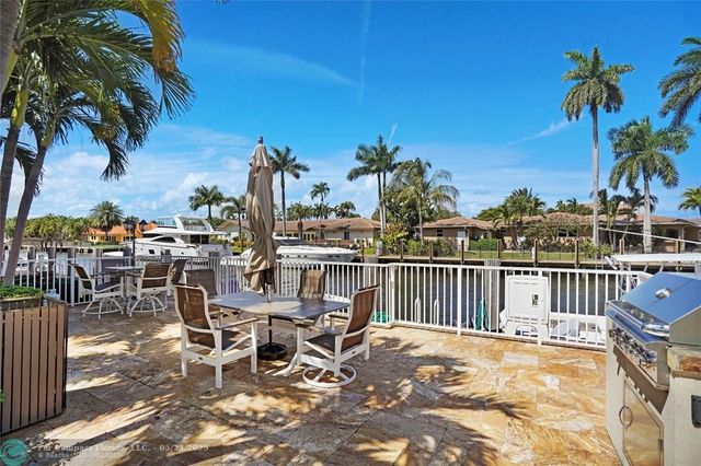 a view of a swimming pool with outdoor seating and plants