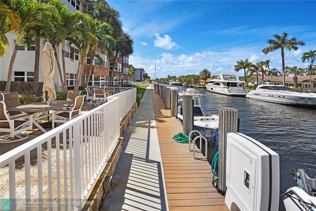 a view of a balcony with two chairs and wooden floor