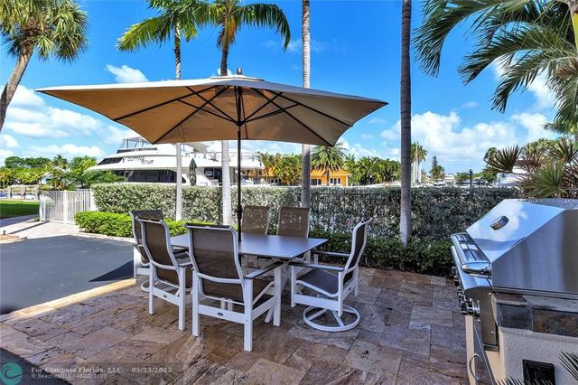 a view of an outdoor space with furniture and umbrella