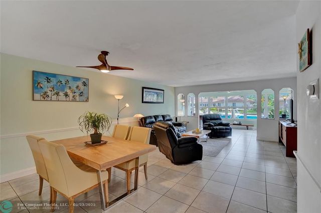 a living room with furniture a couch and a potted plant