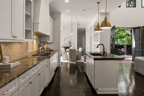 a kitchen with stainless steel appliances a sink stove and cabinets