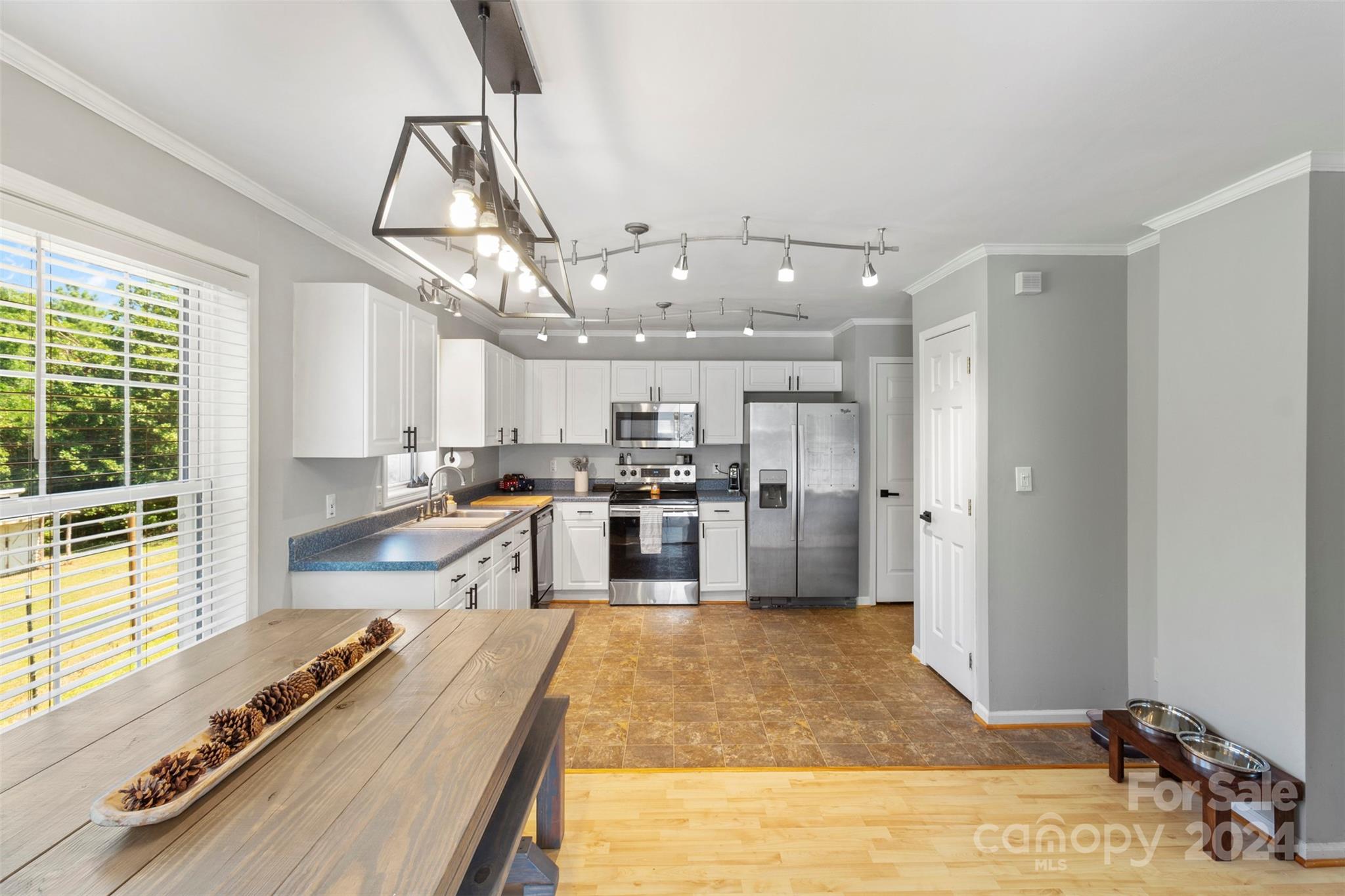 852 Langley Drive Chester, SC 29706 - Photo 11 of 35 a kitchen with kitchen island a counter top space a sink stainless steel appliances and cabinets