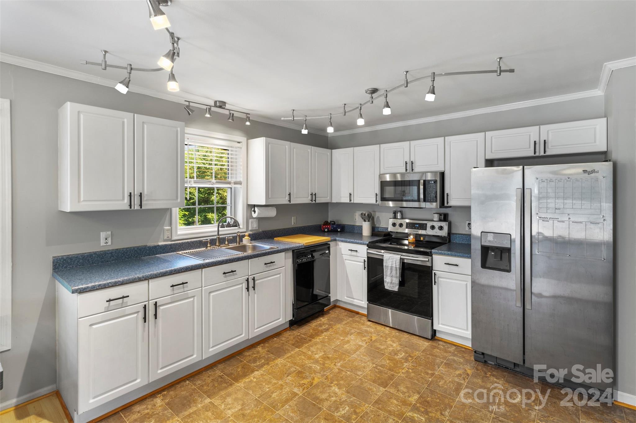 852 Langley Drive Chester, SC 29706 - Photo 13 of 35 a kitchen with white cabinets and stainless steel appliances