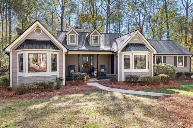 a front view of a house with sitting area and porch