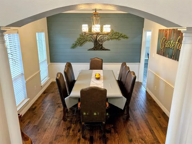 a view of a dining room with furniture and wooden floor