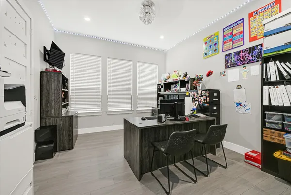 a view of a workspace with furniture and a kitchen