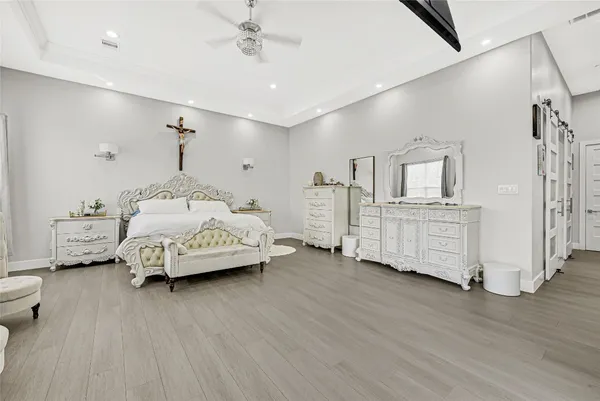 a bedroom with furniture and a wooden floor