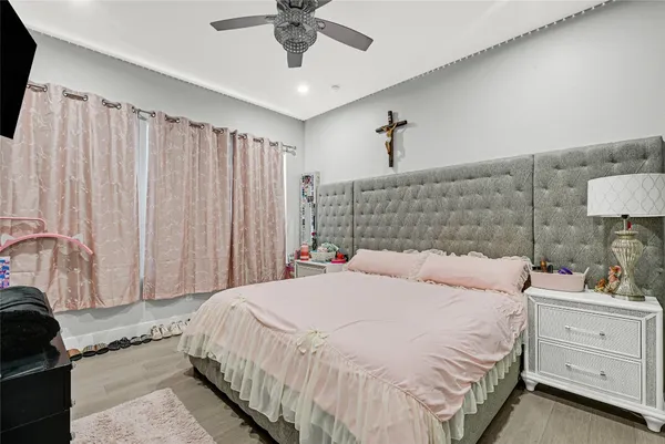 a bedroom with a bed and a chandelier