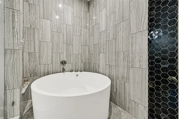 a white bath tub sitting in a bathroom