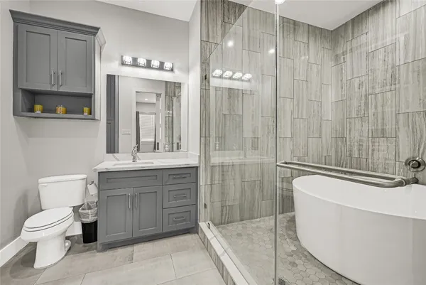 a bathroom with a toilet a sink and glass door