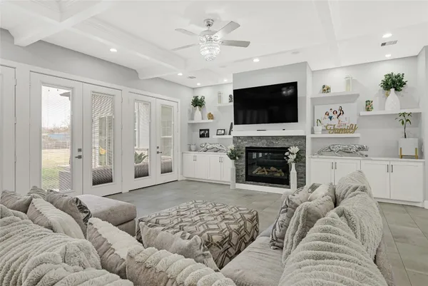 a living room with furniture a flat screen tv and a fireplace