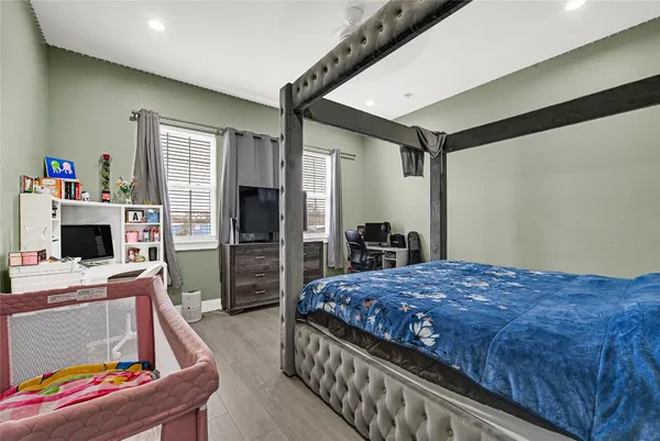 a bedroom with a bed and a flat screen tv