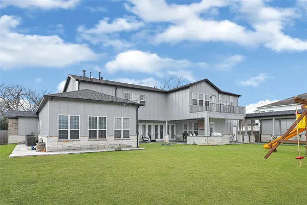a view of a house with a swimming pool and a yard