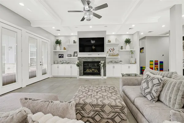 a living room with furniture a flat screen tv and a fireplace