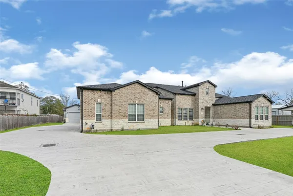 a front view of a house with a garden and yard