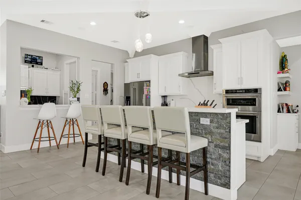 a view of a workspace with furniture and a kitchen