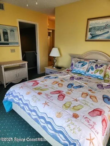 a bedroom with a bed and cupboard