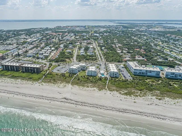 a dining room with furniture a chandelier and wooden floor