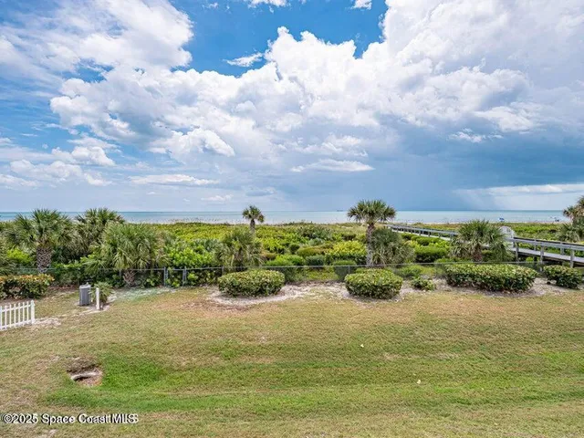 a view of a patio with table and chairs and potted plants