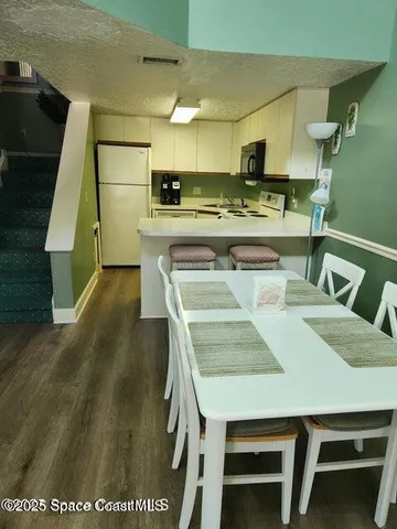 a kitchen with a table chairs and a stove