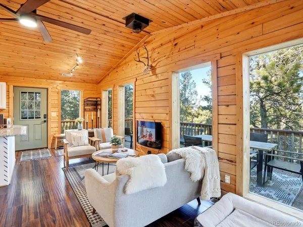 a living room with furniture and kitchen view