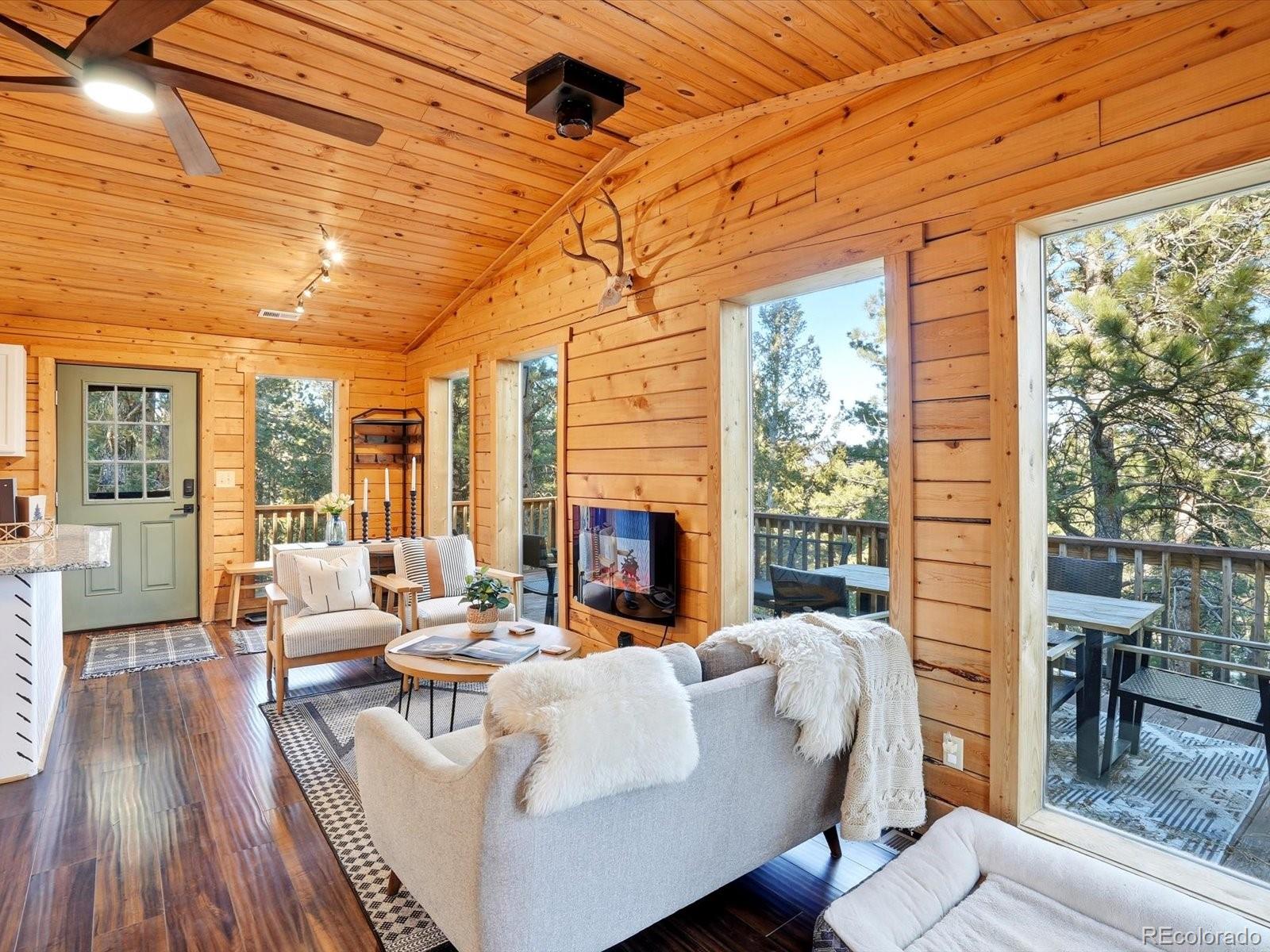 201 Moss Rock Road Bailey, CO 80421 - Photo 11 of 43 a living room with fireplace furniture and a large window