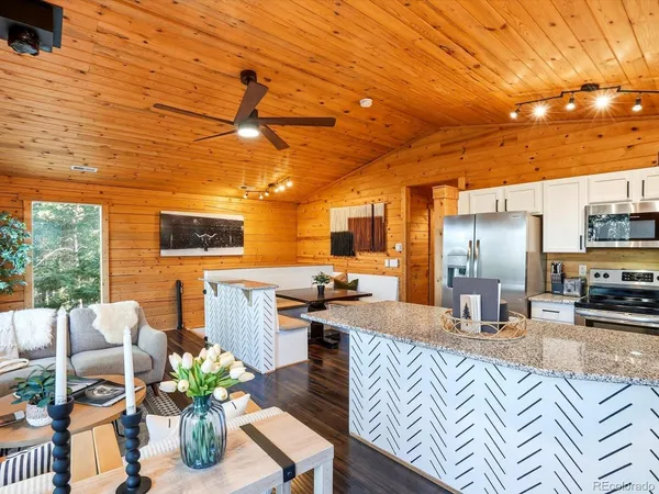 a living room with fireplace furniture and a large window