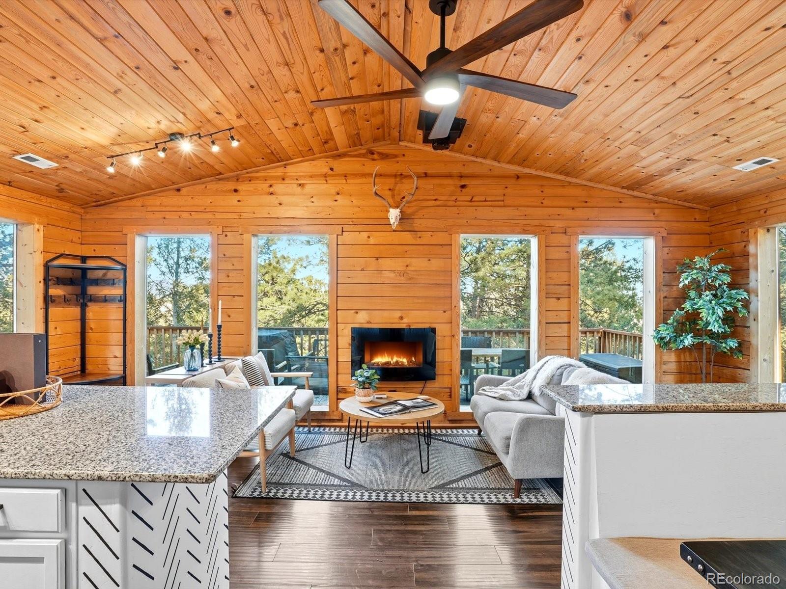 201 Moss Rock Road Bailey, CO 80421 - Photo 15 of 43 a living room with fireplace furniture and a large window