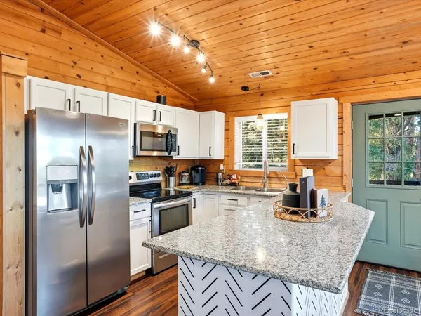 a kitchen with stainless steel appliances a stove sink and microwave