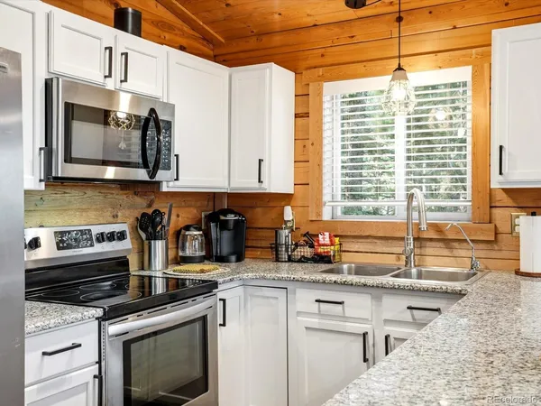 a kitchen with a sink stove and refrigerator