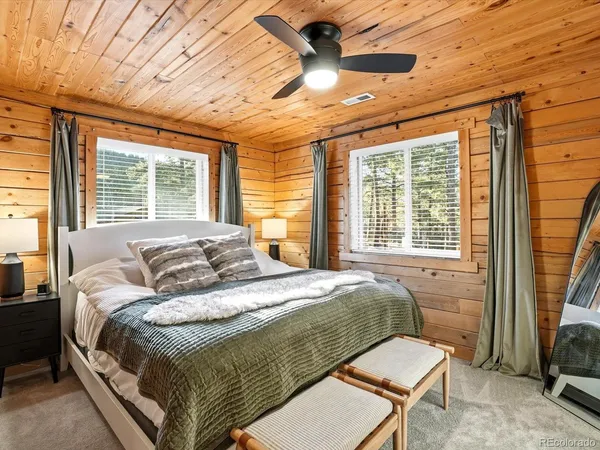 a bedroom with a bed and a chandelier